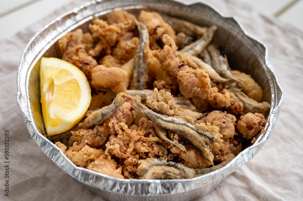 Spanish sea food, cripsy deep fried baby octopus, fish, calamari rings served with lemon Spanish sea food, cripsy deep fried baby octopus, fish, calamari rings served with lemon