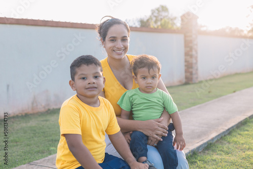 Hispanic family sitting in the park, very smiling