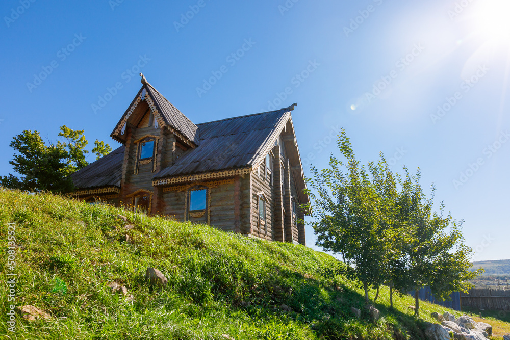 Russian wooden hut against the blue sky. Old village hut. Peasant dwelling. Russian wooden hut against the blue sky. Old village hut. Peasant dwelling.
