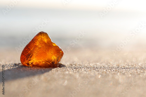 Fototapeta Naklejka Na Ścianę i Meble -  Amber washed ashore on a sandy beach