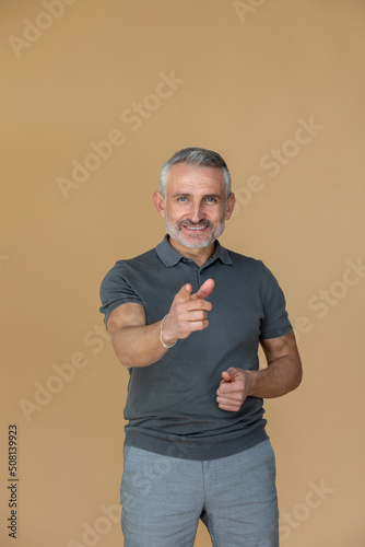 A man in a grey tshirt stretching his arm forward