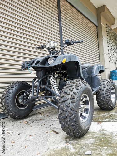 Image of used black in color all terrain vehicle. Selective focus. 