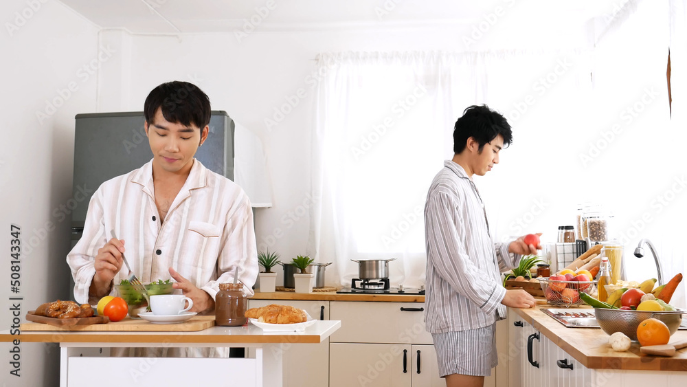 Happy gay couple enjoy breakfast in kitchen drinking coffee. Two best friends LGBTQ relation partner home cooking. Happiness romance homosexual marriage lifestyle. Two men together love friendship. Happy gay couple enjoy breakfast in kitchen drinking coffee. Two best friends LGBTQ relation partner home cooking. Happiness romance homosexual marriage lifestyle. Two men together love friendship.