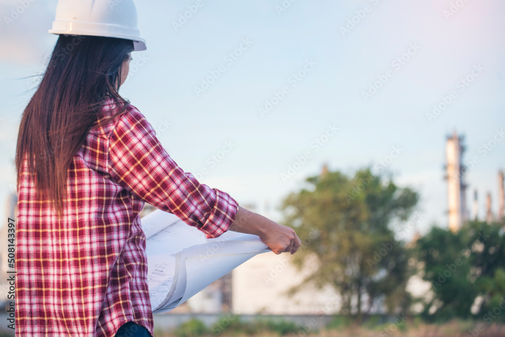 Woman construction engineer hold blueprint wear plaid shirt safety white hard hat at construction site industry labor worker. Architecture Female engineer civil worker look at blueprint real estate Woman construction engineer hold blueprint wear plaid shirt safety white hard hat at construction site industry labor worker. Architecture Female engineer civil worker look at blueprint real estate