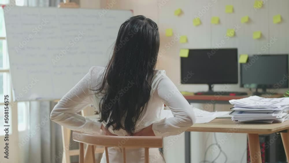 Back View Of Asian Woman Having Backache While Working Hard With Documents At The Office
Back View Of Asian Woman Having Backache While Working Hard With Documents At The Office