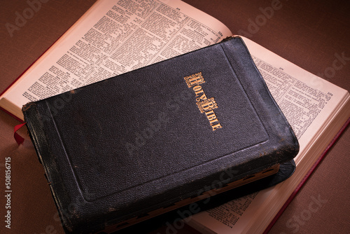Vintage Holy Bible with leather cover and a concordance for study in the background. Antique copy. photo