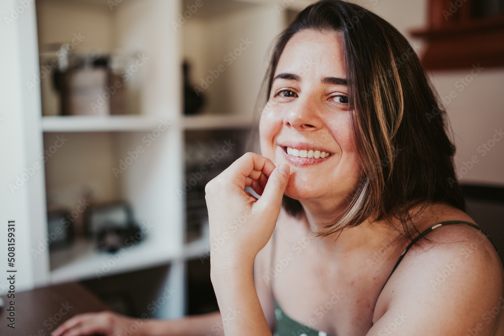 Woman smiling in front of computer working from home Woman smiling in front of computer working from home