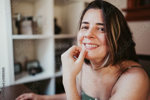 Woman smiling in front of computer working from home
