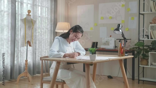 Asian Woman Designer Is Drawing On The Layout Bond At The Office
 photo