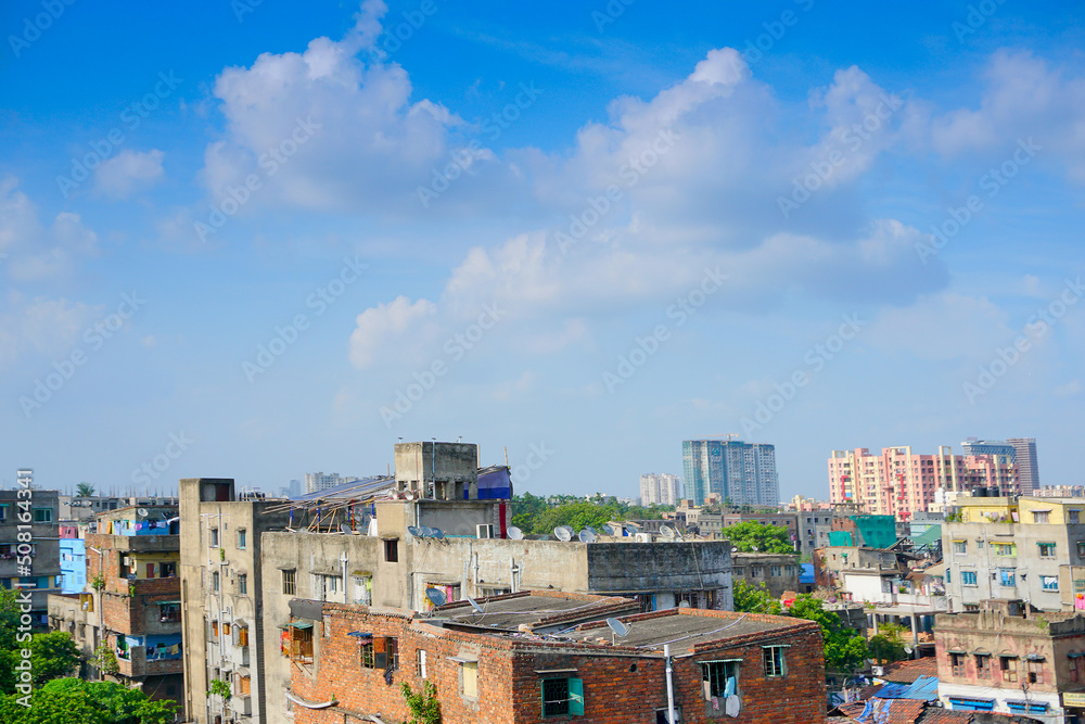 Modern and old architecture of buildings, blue sky and white clouds in background. Kolkata, West Bengal, India.