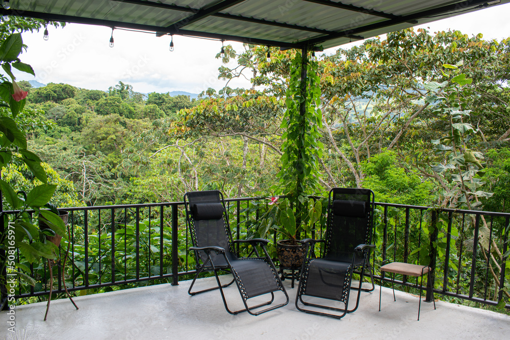 Balcony in the forest with two black chairs in Costa Rica