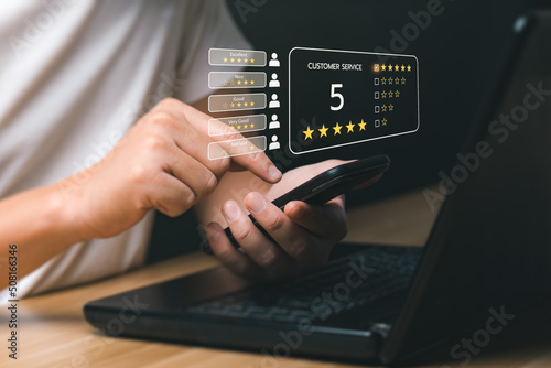 Customer satisfaction concept. Hands of a business man using a smartphone to comment 5 stars. with copy space. 5 star satisfaction, Excellent business rating experience