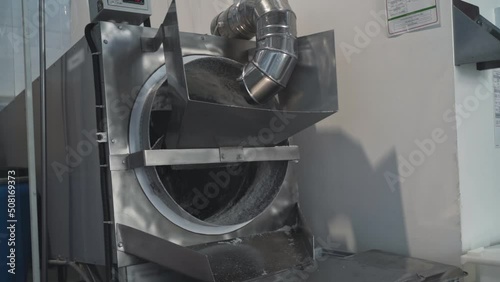 industrial drum roaster is designed for roasting peanuts, seeds and coffee, nuts. Coconut flakes are roasted in a production roaster