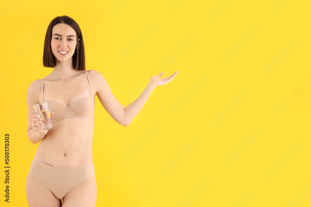 Concept of weight loss with thin girl on yellow background Concept of weight loss with thin girl on yellow background