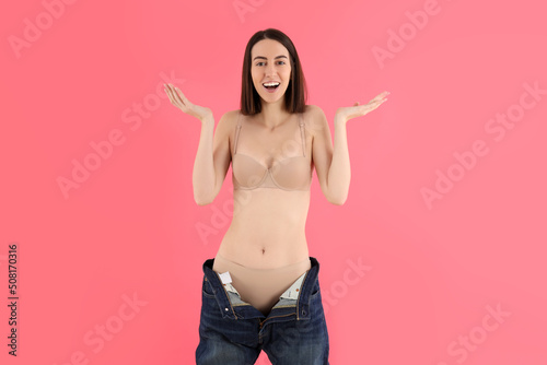 Concept of weight loss with thin girl on pink background