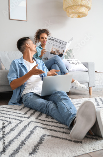 Young man with laptop talki...