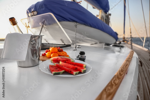 Fresh fruits with cold champagne and photo camera on deck of yacht © Pixel-Shot