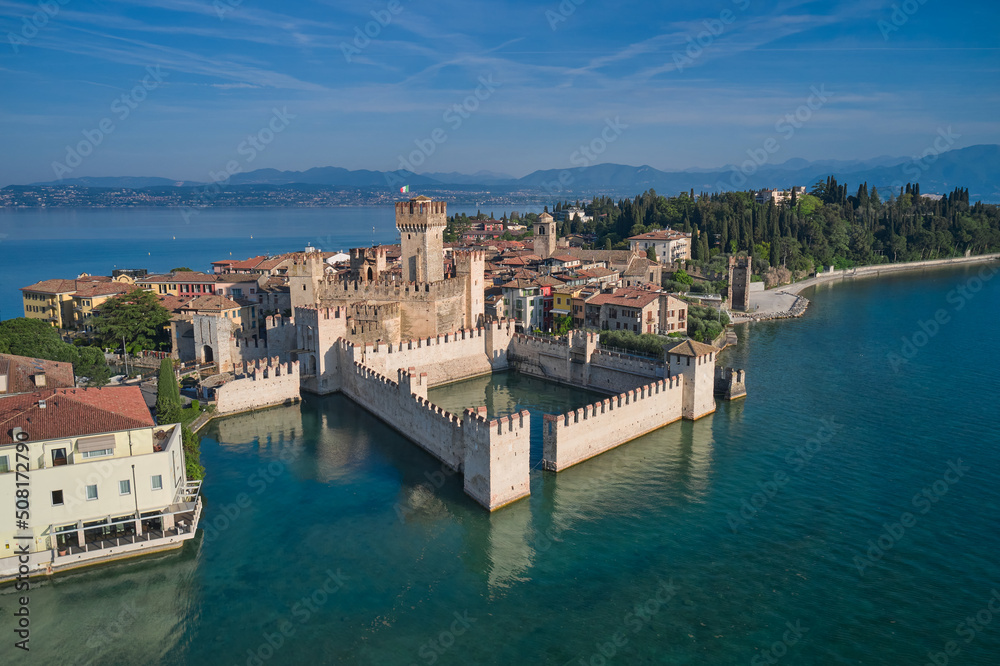 Aerial view of Sirmione, an ancient village on southern Garda Lake. Popular travel destination on Lake Garda in Italy. Scaligero Castle drone view. Sirmione top view.