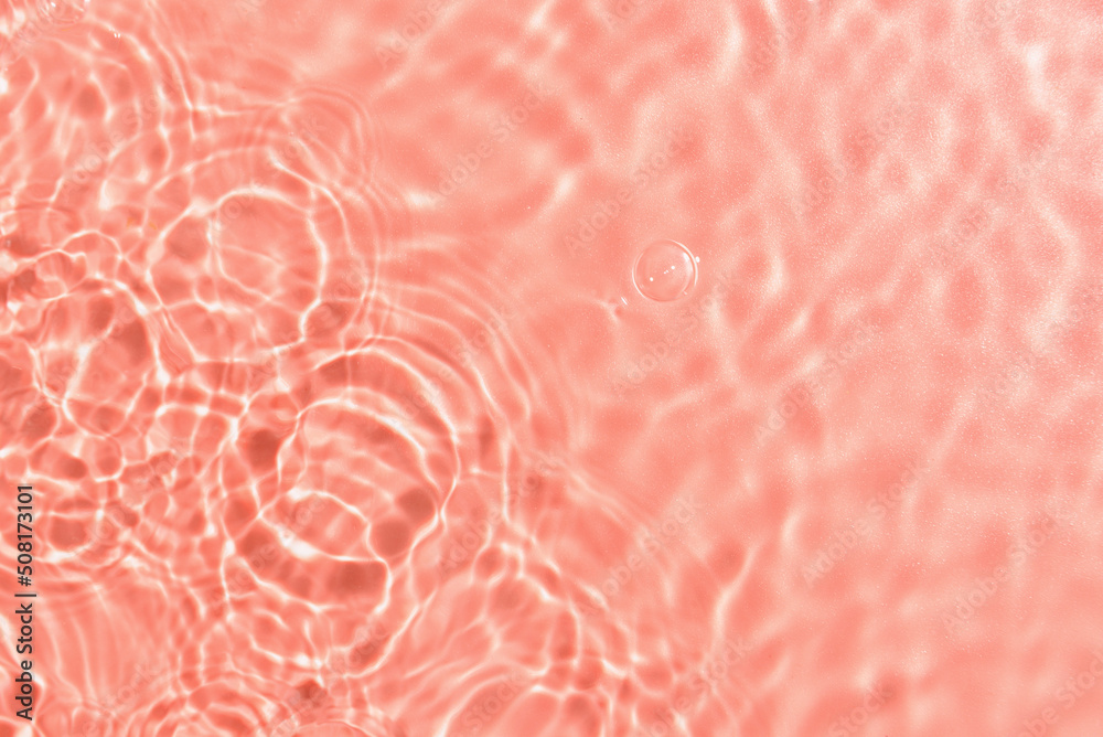 Texture of water with ripples on pink background, closeup Texture of water with ripples on pink background, closeup