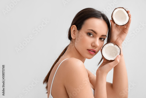 Young woman with coconut on...