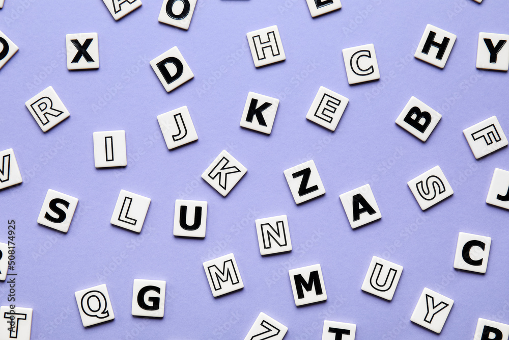 Different letters on violet background. Alphabet concept Different letters on violet background. Alphabet concept