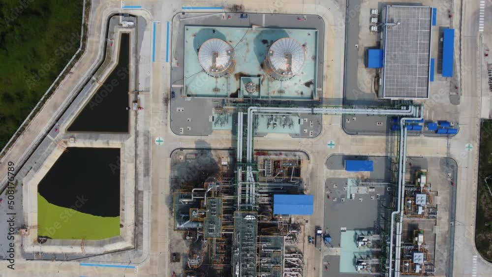 Aerial view of an oil refinery, chemical plant, or power plant with several storage tanks and pipelines from above. Drone footage in 4K resolution. Aerial view of an oil refinery, chemical plant, or power plant with several storage tanks and pipelines from above. Drone footage in 4K resolution.