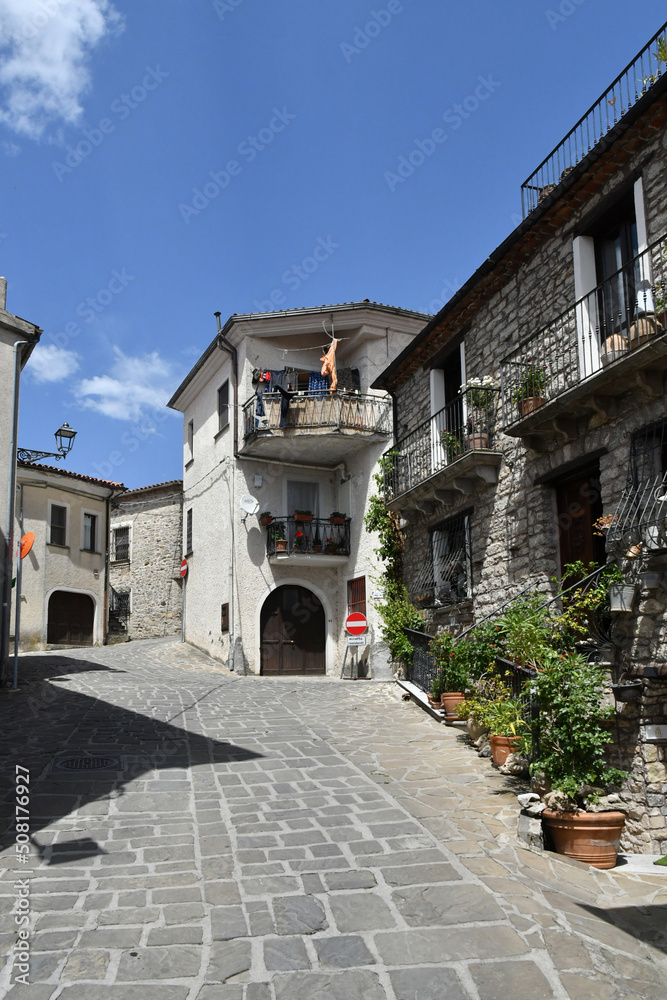A narrow street between the old houses of Sasso di Castalda, a village in the mountains of Basilicata, Italy.