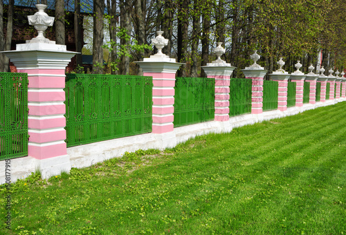 Fence and green lawn in the park