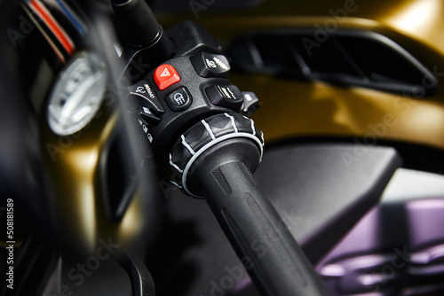 Motorcycle handle bar with buttons on blurred background © dimaris