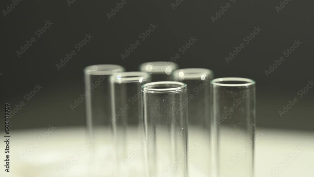 Close-up of a laboratory assistant dripping blood from a pipette into a test tube. Close-up of a laboratory assistant dripping blood from a pipette into a test tube.