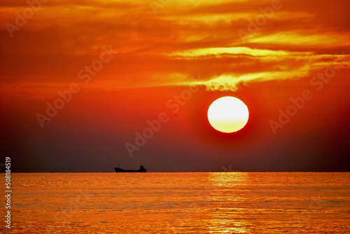 Fototapeta Naklejka Na Ścianę i Meble -  Evocative Colourful Sunset  Over The Sea Of Marmara Near Istanbul In Turkey With Boat