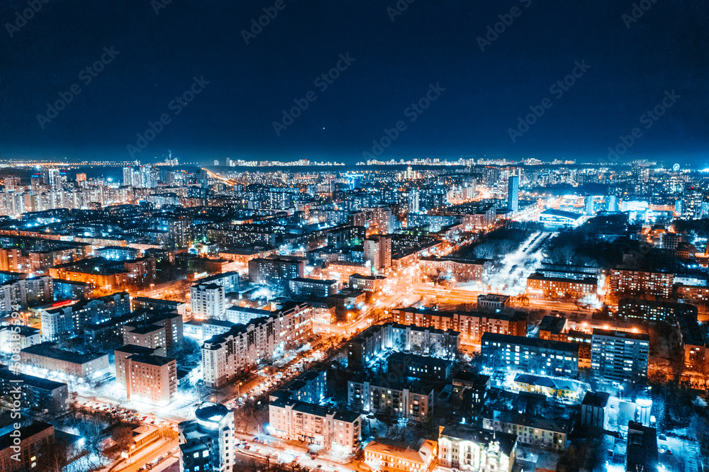 Aerial view of the night modern city. Bright lights of the night streets. Ekaterinburg. Russia