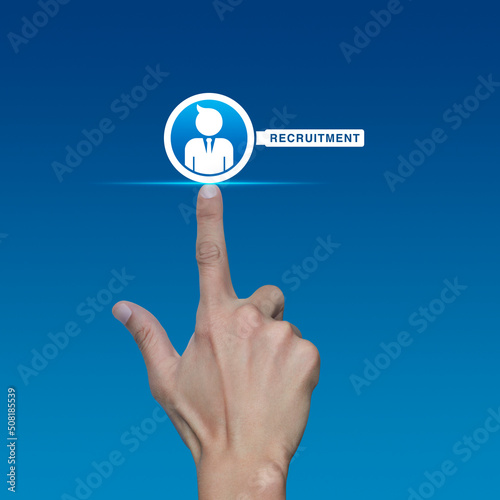 Hand pressing businessman with magnifying glass icon over light blue background, Business recruitment service concept