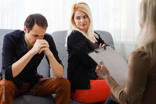 love, family, phychology and relationship problems concept - young couple with a problem at psychologist office photo