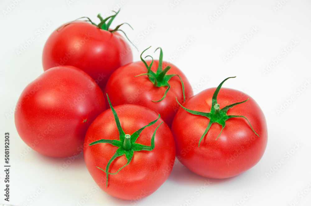 ripe tomatoes on a white background. the concept of cooking tomato sauce. red vegetables on a light texture. juicy pink tomatoes on the table ripe tomatoes on a white background. the concept of cooking tomato sauce. red vegetables on a light texture. juicy pink tomatoes on the table