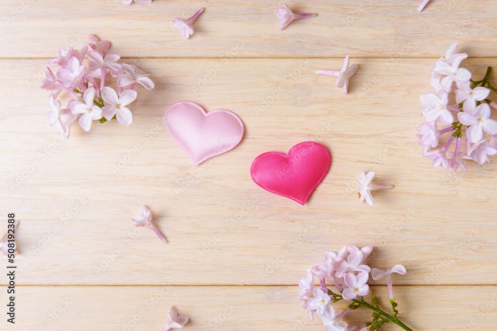 Two valentines hearts and blooming lilacs flowers. Valentine’s day and Love concept Two valentines hearts and blooming lilacs flowers. Valentine’s day and Love concept