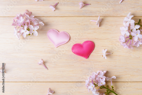 Two valentines hearts and blooming lilacs flowers. Valentine’s day and Love concept