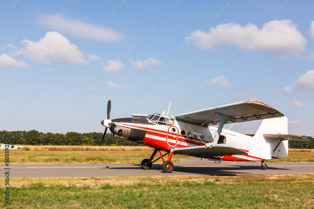 Small aircraft with propeller in parking lot. Small aircraft with propeller in parking lot.