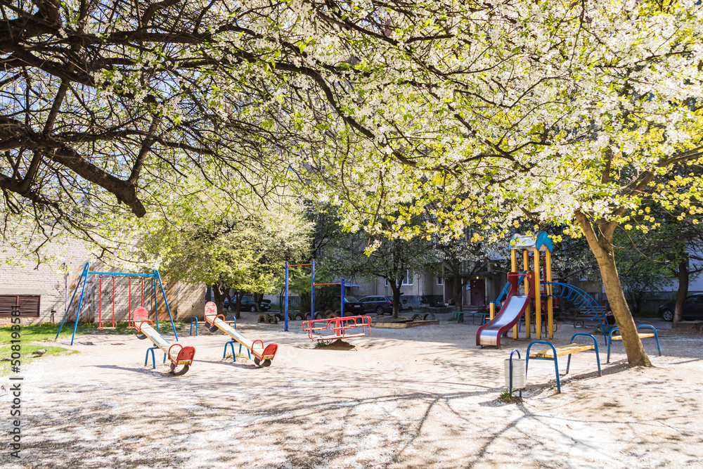 The playground is angry home and cherry blossoms above it. ?olor playground covered with cherry blossom The playground is angry home and cherry blossoms above it. ?olor playground covered with cherry blossom