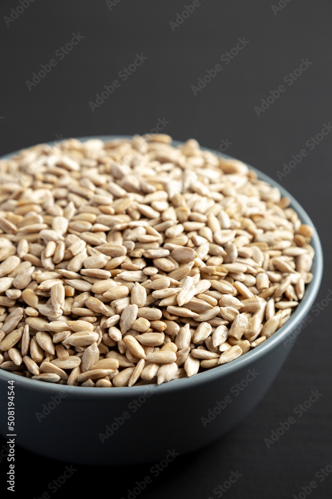 Raw Organic Sunflower Seed Kernels in a Blue Bowl, side view. Close-up. Raw Organic Sunflower Seed Kernels in a Blue Bowl, side view. Close-up.
