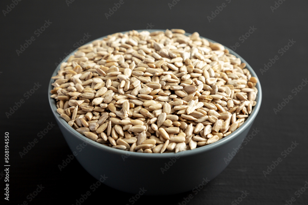 Raw Organic Sunflower Seed Kernels in a Blue Bowl, side view. Close-up.
