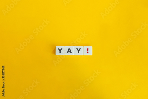 Yay Exclamation on Letter Tiles on Yellow Background. Minimal Aesthetics.