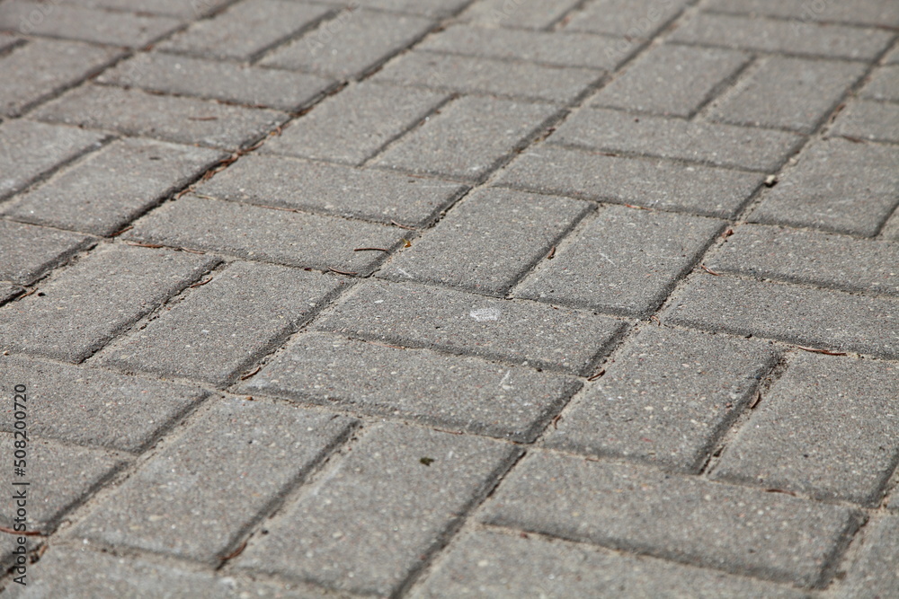 Diagonal paving tiles. Road gray background. Diagonal paving tiles. Road gray background.