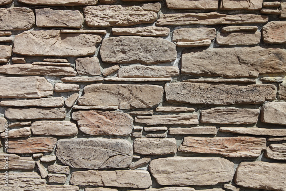 Fototapeta premium The wall is made of finishing stone. Stone tiles. Slate stone.