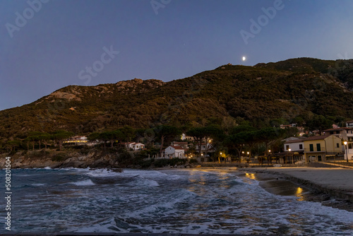 Coast and sea near Sant'Andrea on the island of Elba in Italy with blue sky in summer at dusk