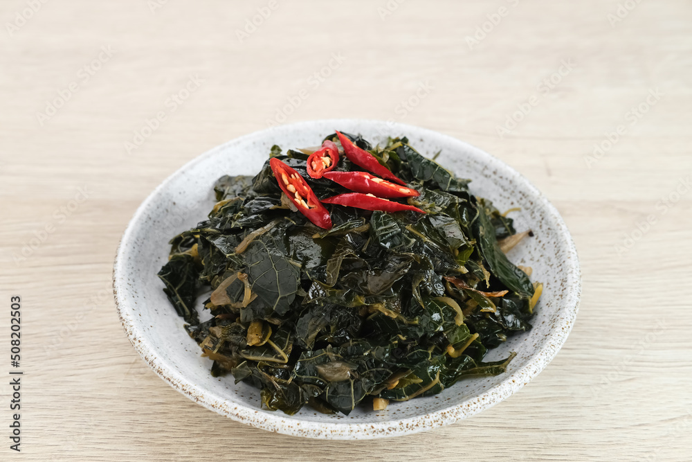 Stir Fry Papaya Leaves or Tumis Daun Pepaya, a traditional Indonesian dish made from boiled papaya leaves stir-fried with spices and chilies.
Stir Fry Papaya Leaves or Tumis Daun Pepaya, a traditional Indonesian dish made from boiled papaya leaves stir-fried with spices and chilies.