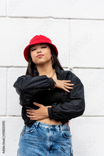 Young latin woman hip hop dancing in the street with a red hat, Panama, Central America - stock photo © Amaiquez