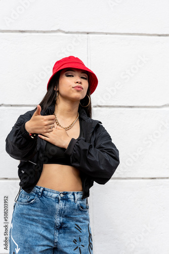 Young latin woman hip hop dancing in the street with a red hat, Panama, Central America - stock photo © Amaiquez