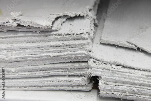 Asbestos sheets in stack - effective insulator for construction photo