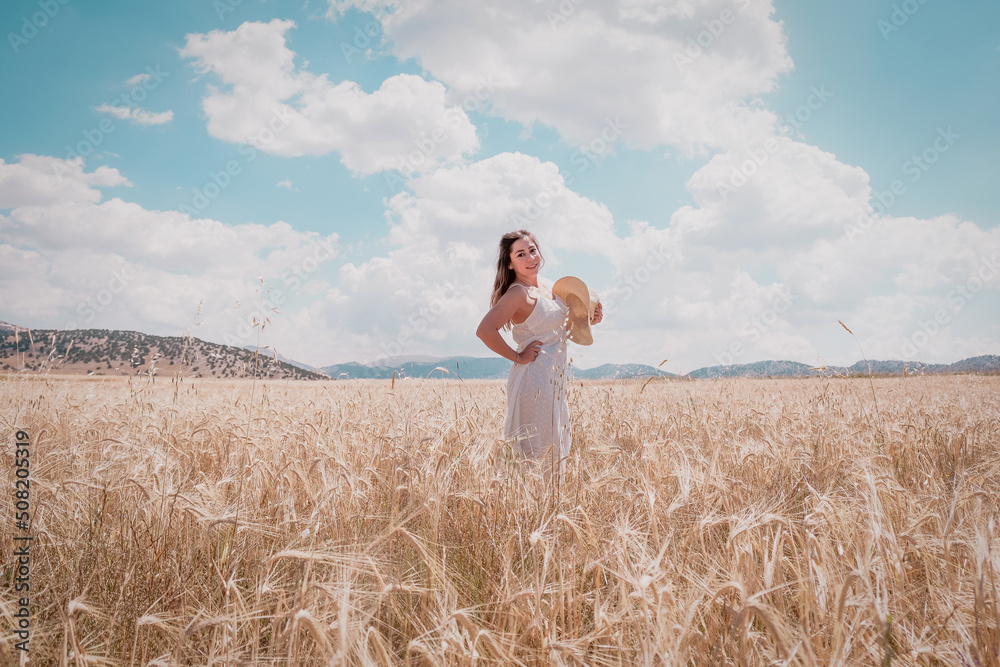 a woman in a white dress among the wheat ears at sunset a woman in a white dress among the wheat ears at sunset